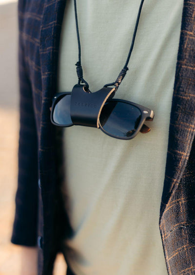 Lifestyle photo of how our sunglasses carrier looks in real life. This in black leather.