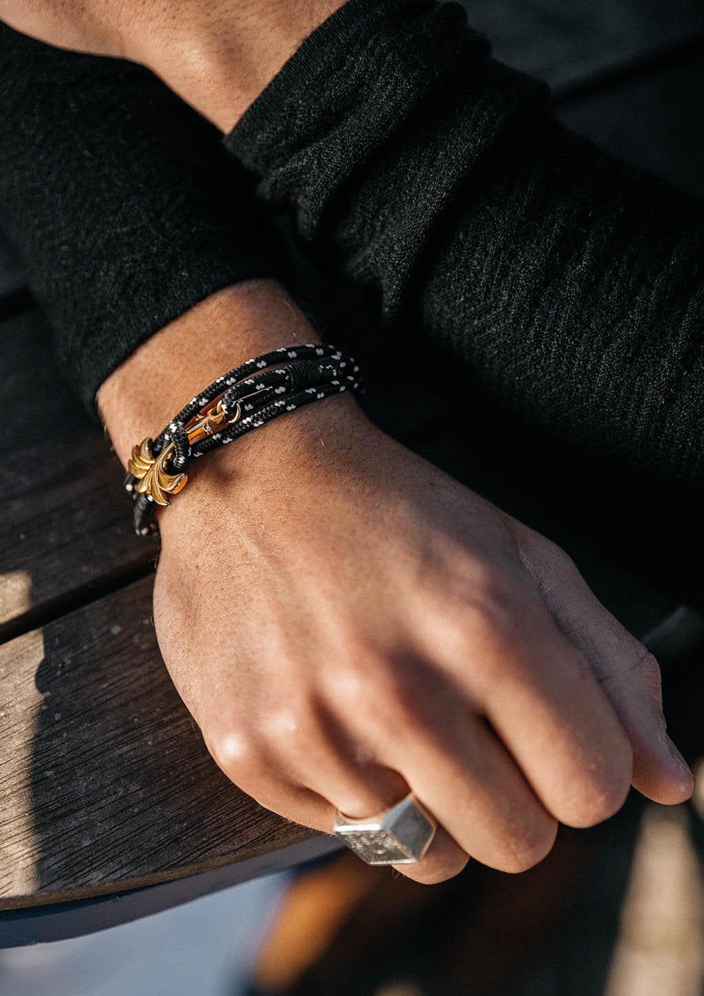 Trophy - Triple - Season two Palm anchor bracelet with black and white nylon band. With black sweater.