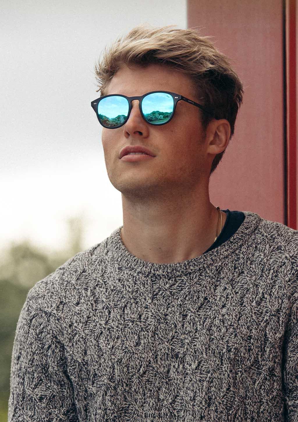 Hybrid - Halo, carbon fiber and acetate sunglasses of the highest quality. On model with blue mirror lenses.
