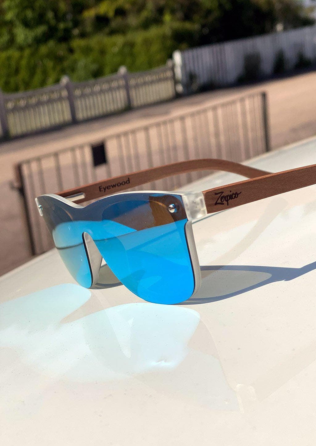 Eyewood tomorrow is our modern cool take on classic models. This is Gemeni with blue mirror lenses. Nice wooden sunglasses. Details from the side outside in the sun.