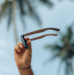 Engraved wooden sunglasses with custom designs.