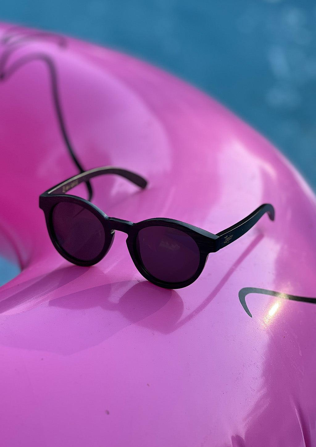 Our handmade round wooden sunglasses called midnight bamboo. Another photo by the pool in Sweden.