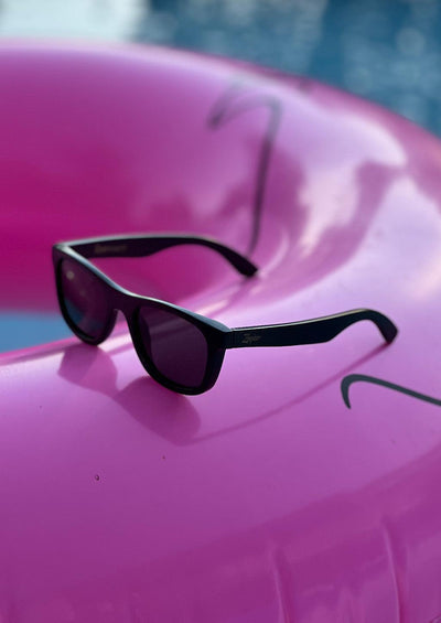 Our handmade wayfarer wooden sunglasses called Obsidian Shade. Sleak photo in the pool.