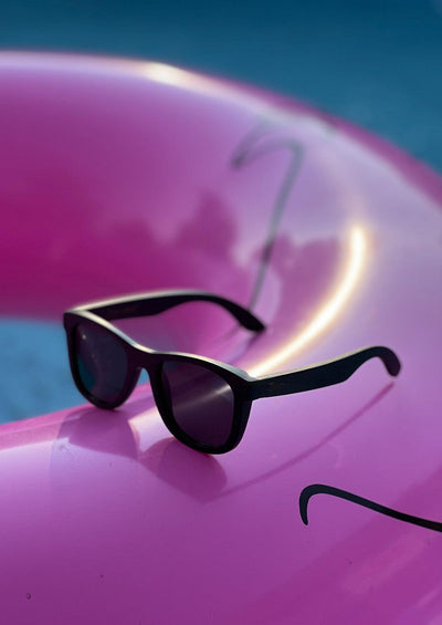 Our handmade wayfarer wooden sunglasses called Onyx Edge. Another photo by the pool.