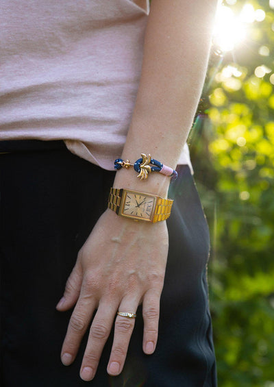 Daybreak - Single - Season two Palm anchor bracelet with pink and blue nylon band. On girl models arm.