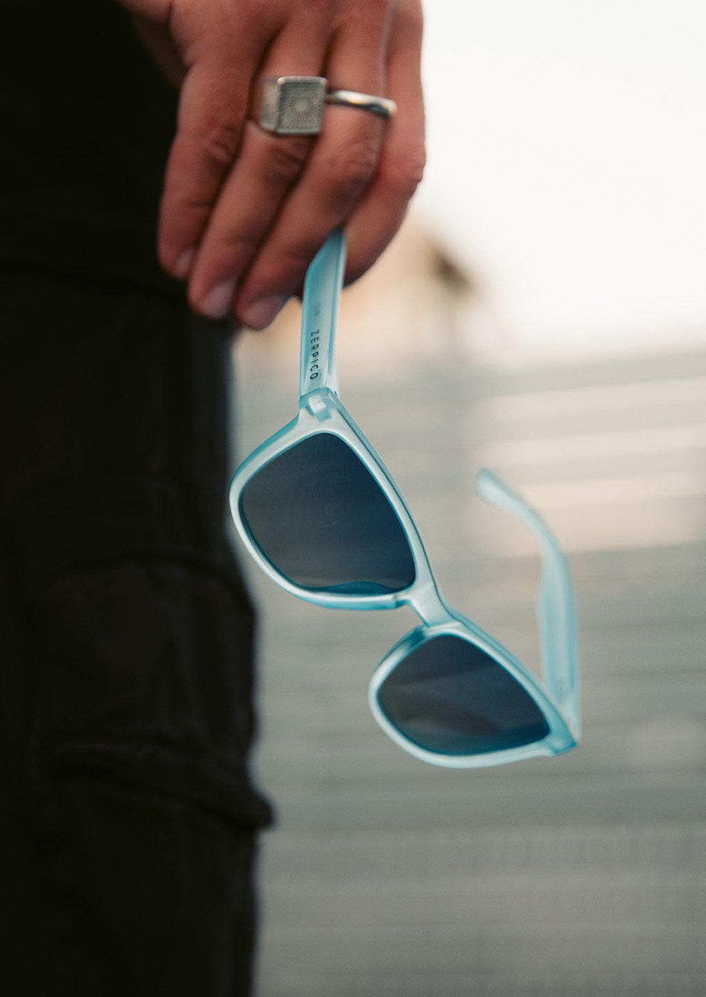 Our Mood V2 is an improved version of our last wayfarers. Plastic body for great quality and durabilty. This is Belize with blue frame and blue lenses. Close up outside.