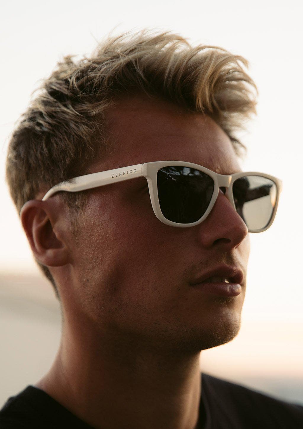 Our Mood V2 is an improved version of our last wayfarers. Plastic body for great quality and durabilty. This is Ace with white frame and black lenses. Lifestyle photo on male model.