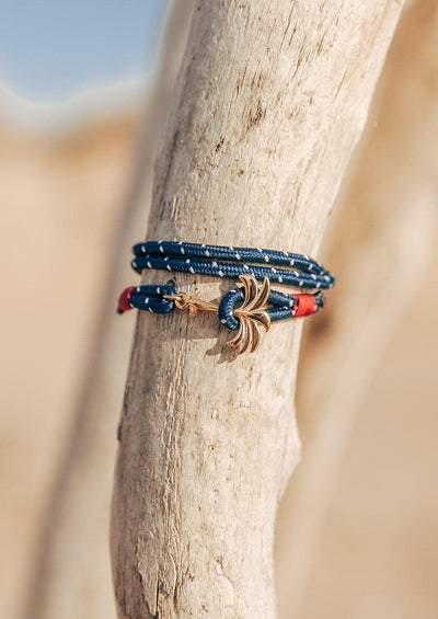 Seven Seas - Triple - Season two Palm anchor bracelet with blue and white nylon band. Close up outside.