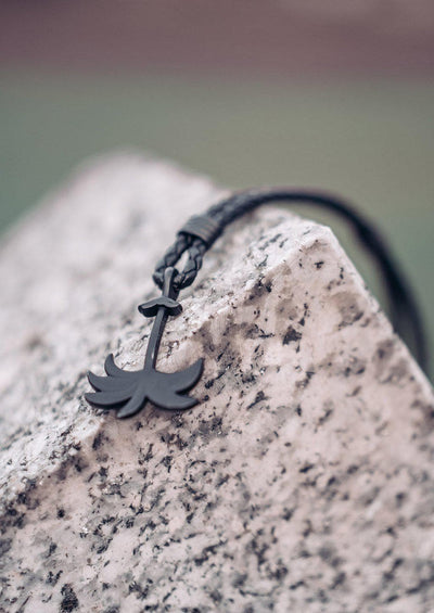Pitch Black - Palm anchor bracelet with black leather. Outside shoot on a rock.