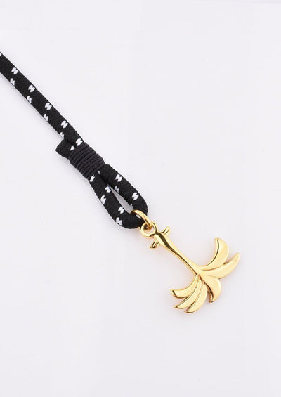 Trophy - Single - Season two Palm anchor bracelet with black and white nylon band. Close up on palm.