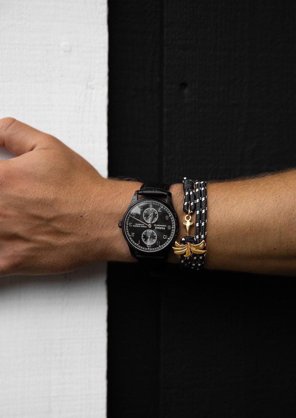 Trophy - Triple - Season two Palm anchor bracelet with black and white nylon band. Black and white wall.
