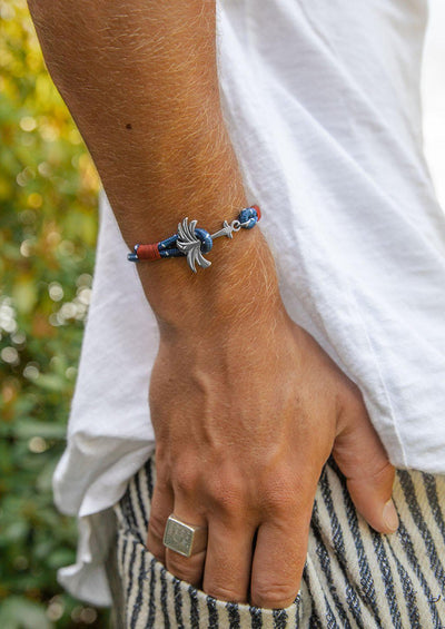 Voyager - Single - Season two Palm anchor bracelet with blue and red nylon band. On male model arm.