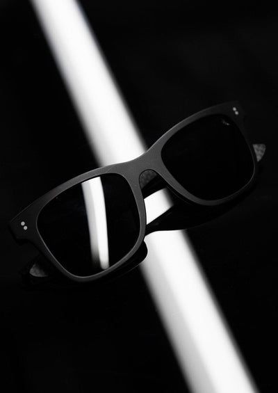 Hybrid - Atom, carbon fiber and acetate sunglasses of the highest quality. Studio shoot of the black frame and black lenses.