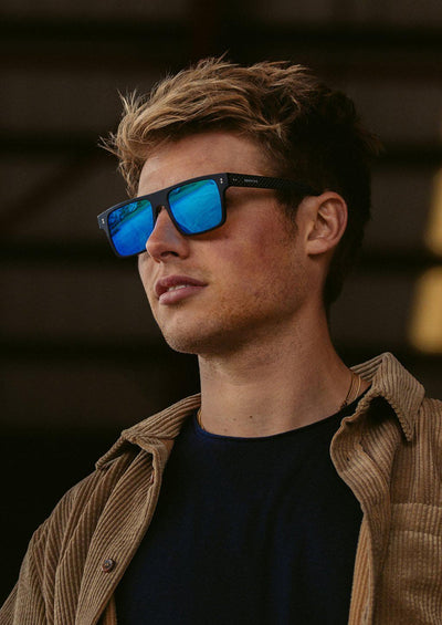 Hybrid - Cubic, carbon fiber and acetate sunglasses of the highest quality. On a model with our blue lenses.
