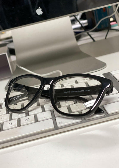 Our Photochromic anti bluelight black glasses that work like two in one. Turns dark in the sun and clear inside.  In Front of the computer.