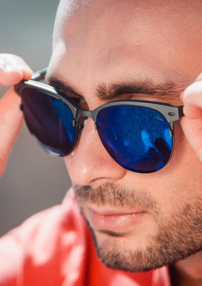 Clubmaster Sunglasses V2 - Gun metal frame with blue lenses on male model.