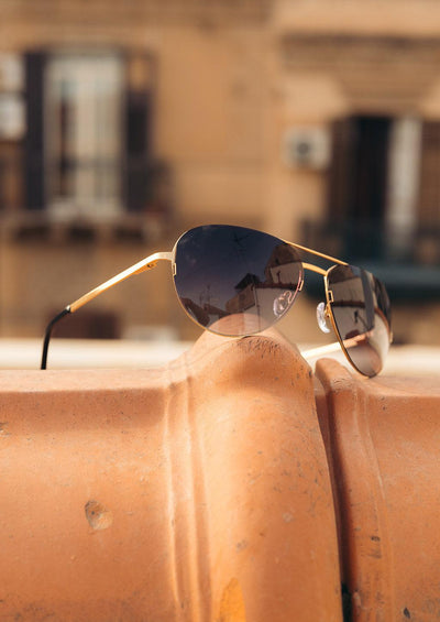 Titan - Titanium Aviator Sunglasses V2 - 24K Gold Plated with real gold. Photo taken outside in Italy on a roof.