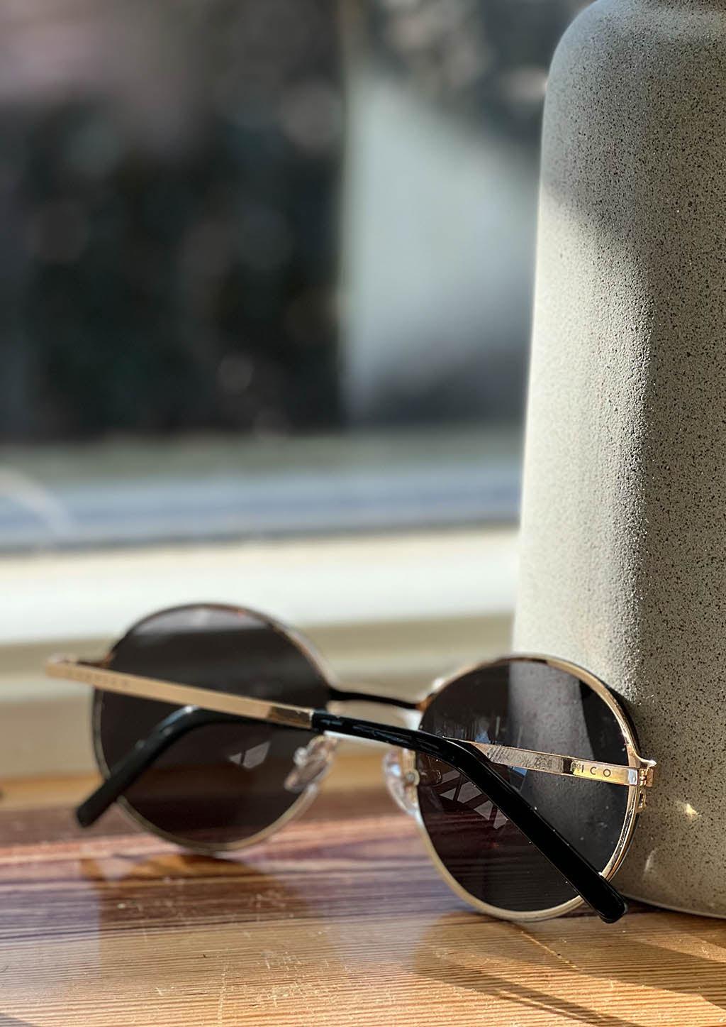 Titan - Titanium Round Sunglasses V2 - 24K Gold Plated with real gold. Photo from the back taken inside a Swedish house.