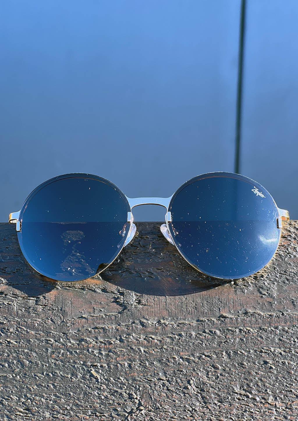 Titan - Titanium Round Sunglasses V2 - 24K Gold Plated with real gold. Photo taken from the front outside.