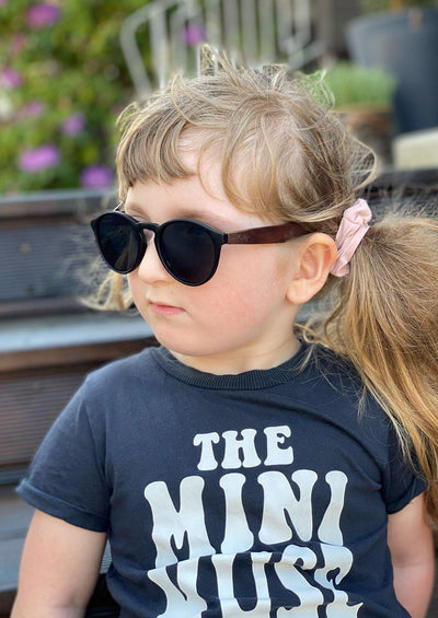 Eyewood Cubs - Simba - Wooden sunglasses for kids. On model in summer Sweden.