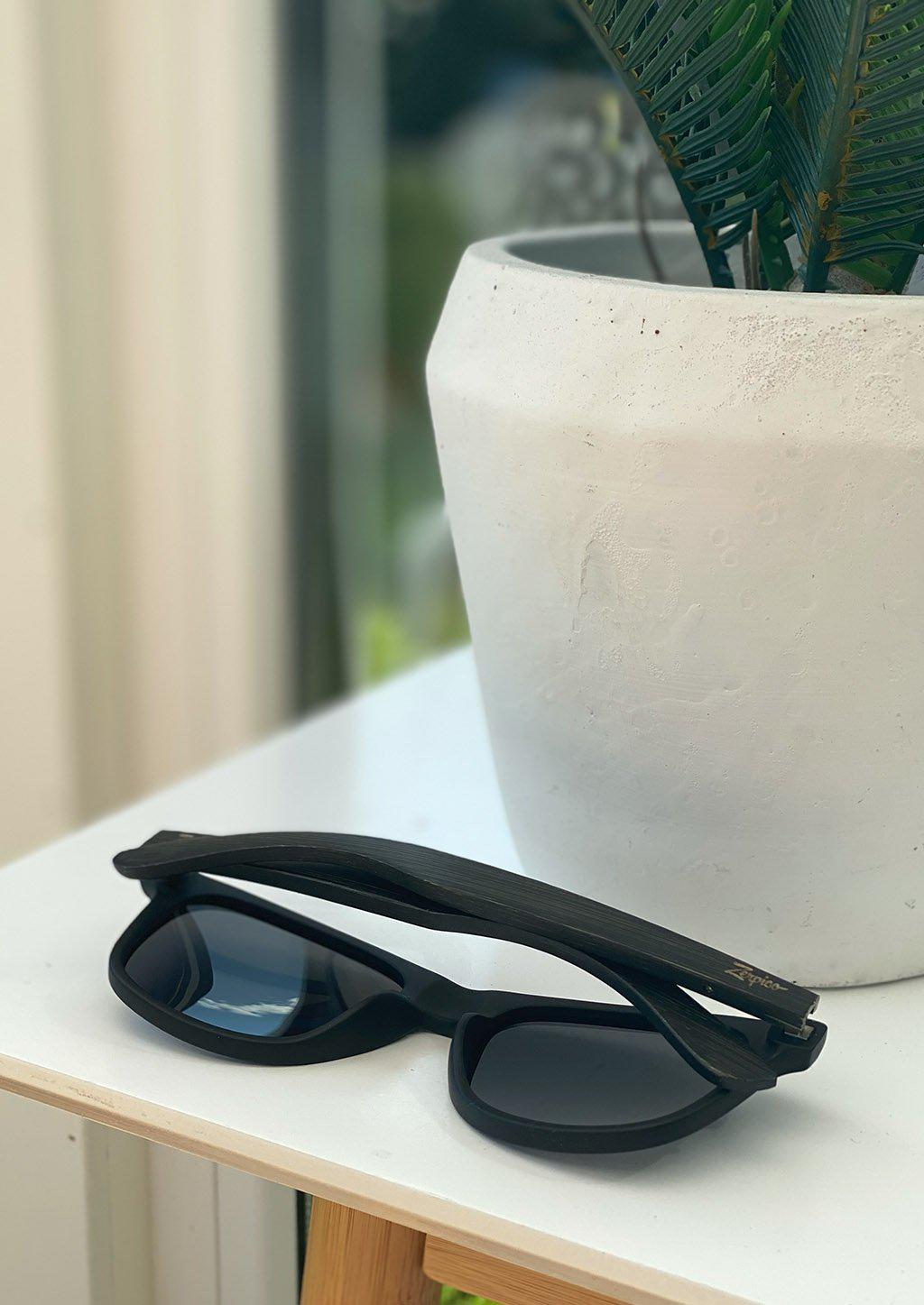 Handmade wooden wayfarers in wood and are guaranteed to give you a natural feeling of comfort and design.  Andariel is a walnut wooden model with black matte plastic front. This special edition pair is made to stand out. Another lifestyle photo showing the colors.