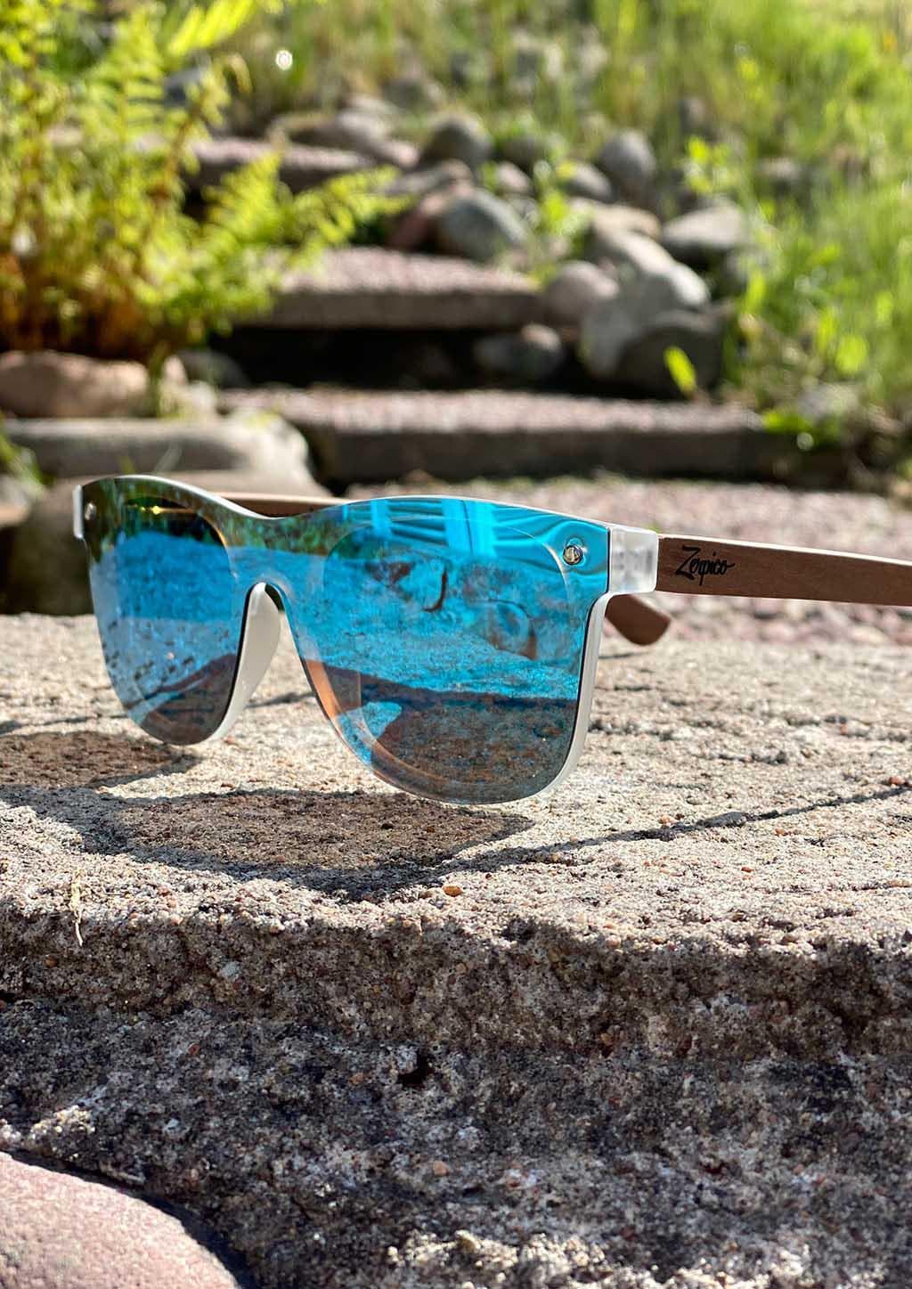 Eyewood tomorrow is our modern cool take on classic models. This is Gemeni with blue mirror lenses. Nice wooden sunglasses. Front in the sun.