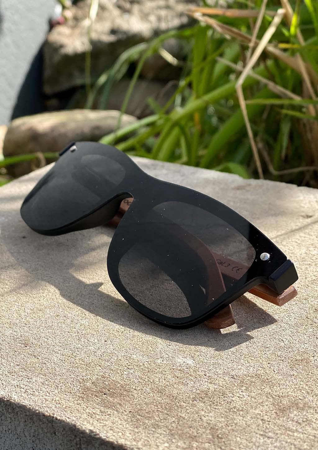 Eyewood tomorrow is our modern cool take on classic models. This is Taurus with black lenses. Nice wooden sunglasses. On a stone, Swedish summer.