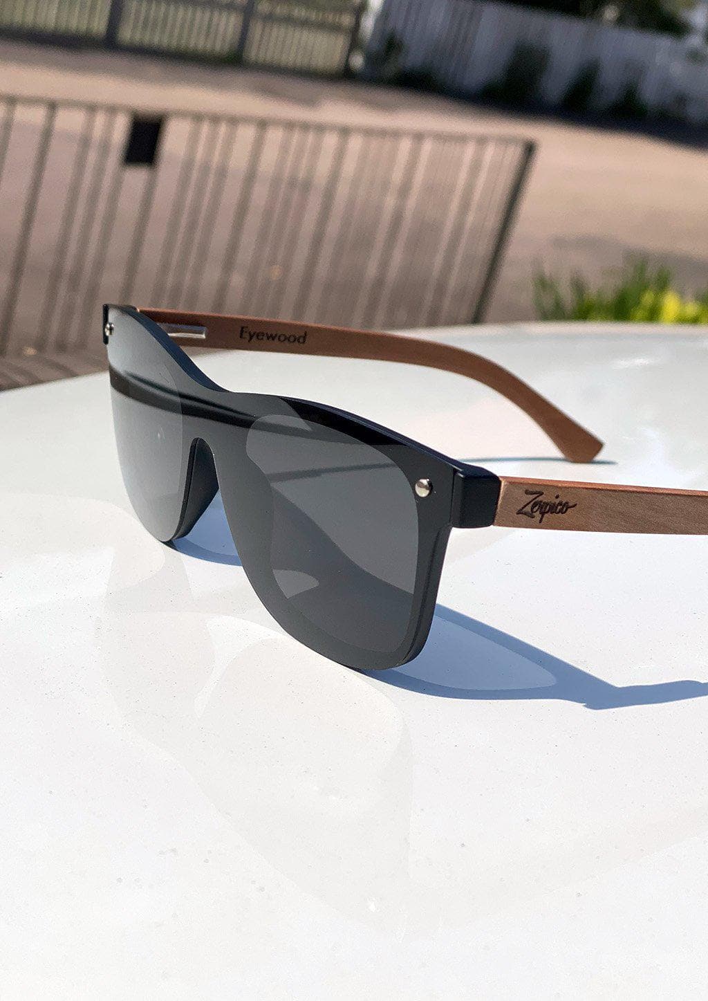 Eyewood tomorrow is our modern cool take on classic models. This is Taurus with black lenses. Nice wooden sunglasses. On White car with details.